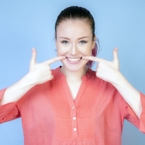 smiling girl with coral color blouse